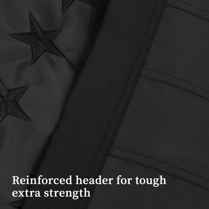 Close-up view of the 3×5 FT Embroidery All Black American Flag by Jetlifee, featuring embroidered stars and a reinforced header for added durability. Caption: "Reinforced header for tough extra strength.