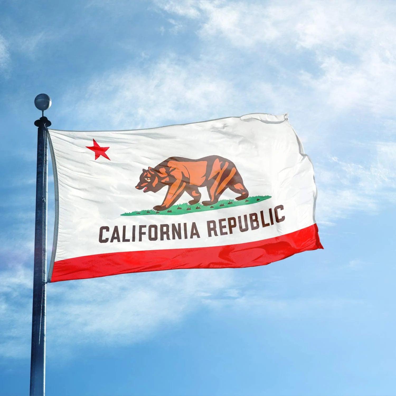 The Jetlifee 3×5 Ft Printed California State Flag, made in the USA from durable 100D Polyester and featuring brass grommets, showcases a grizzly bear, a red star, and the words "California Republic" as it waves proudly against a blue sky with some clouds.